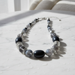 Shades of Black Grey & Silver Rescued Necklace on marble surface