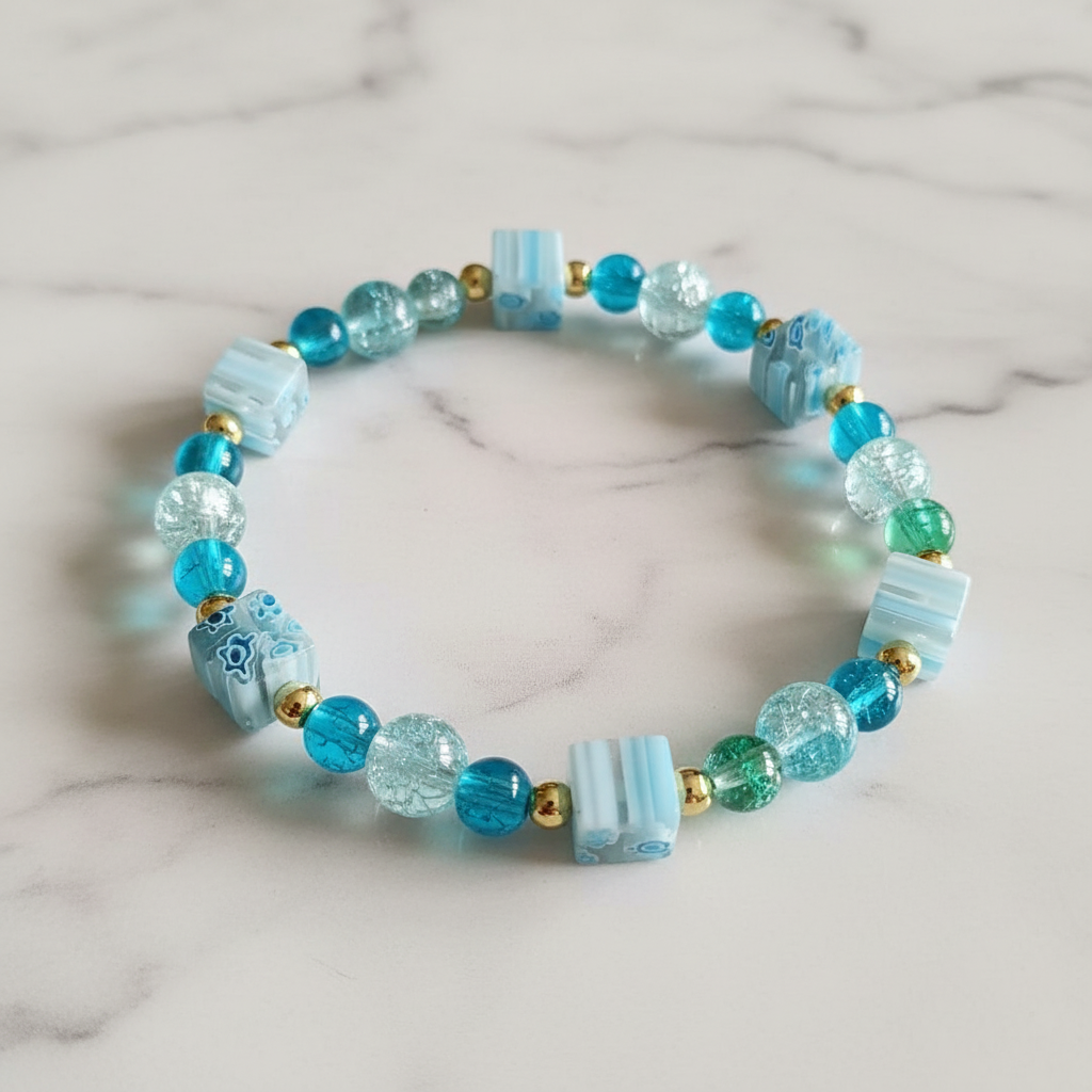 Close-up detail of teal crackle bead bracelet with millefiori square beads