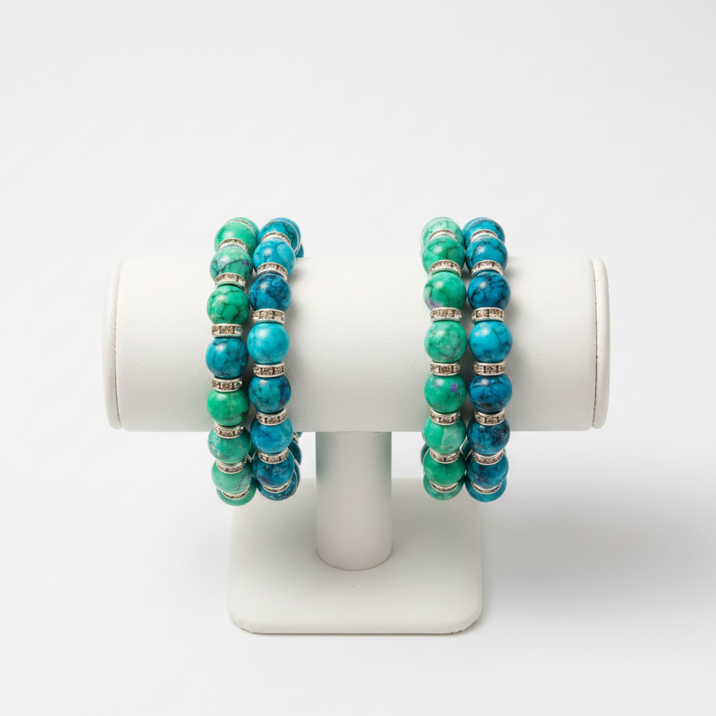 Two turquoise and green marbled beaded bracelets on a jewellery display stand