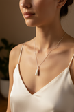 Model wearing white ivory teardrop pendant necklace