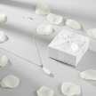 White teardrop necklace with gift box and flower petals