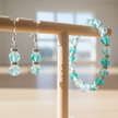 Close-up detail of teal aqua crackle glass beads with silver rhinestone spacers