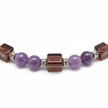Close up detail of round and square purple and brown beads with silver spacers