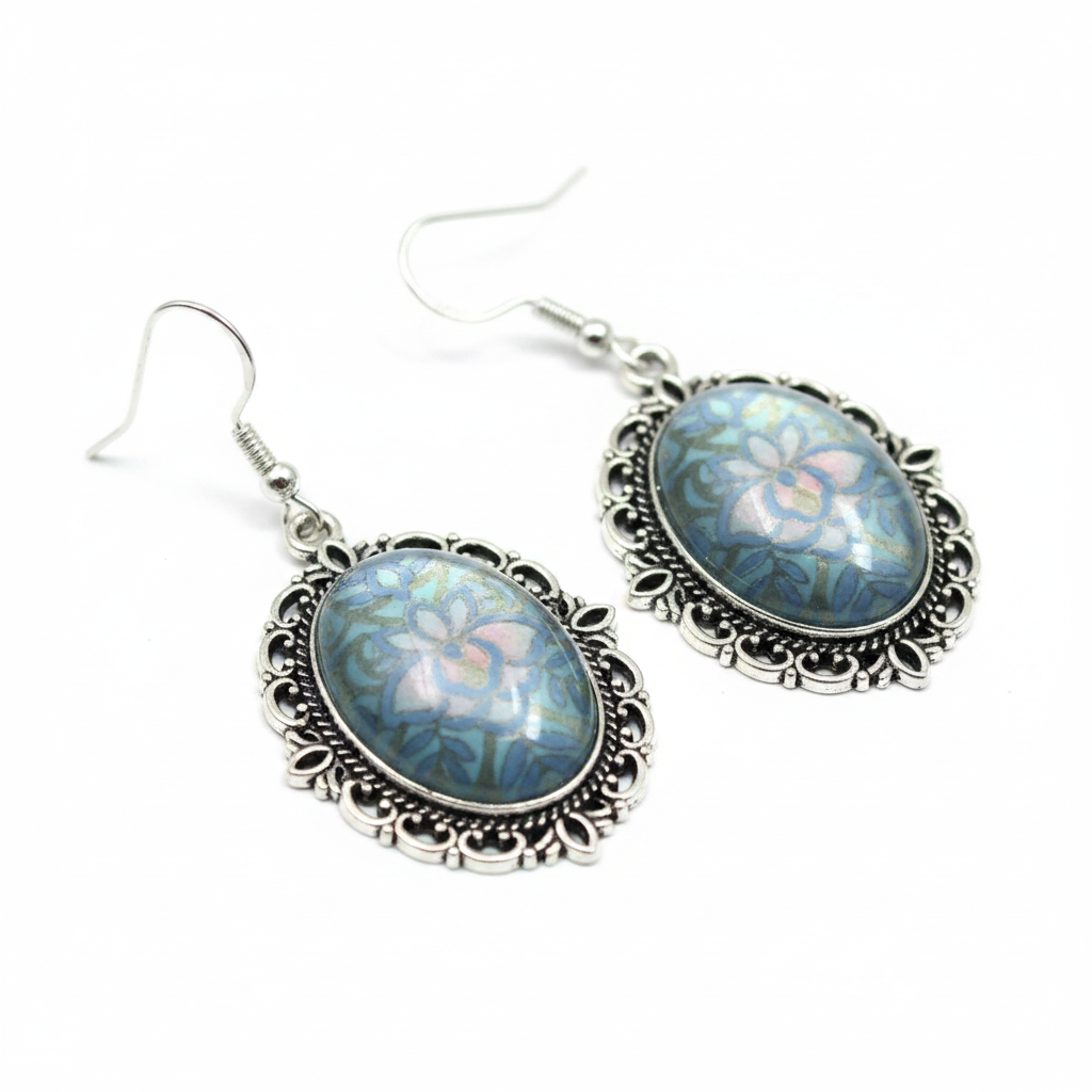 Close-up detail of iridescent blue-grey holographic cabochon and silver filigree earrings