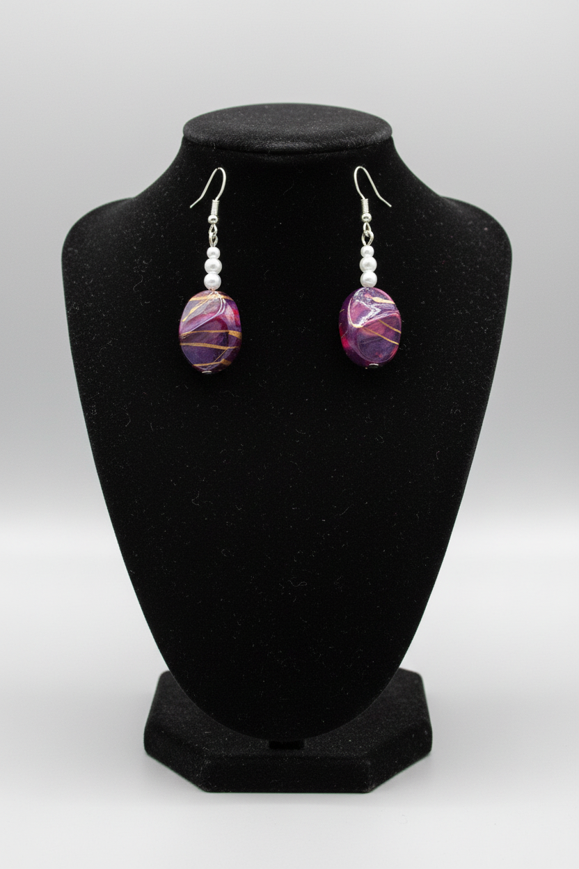 Rescued plum drop earrings displayed on earring stand
