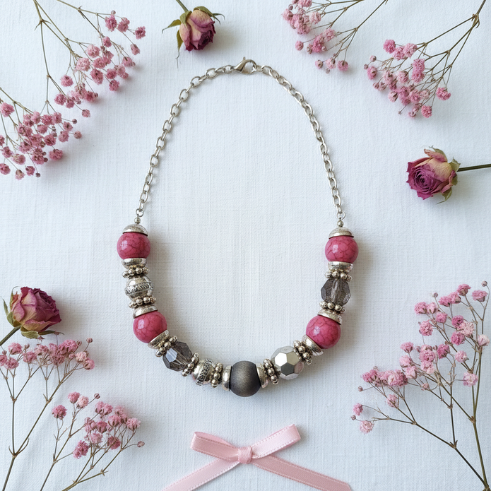 Rescued & Remade pink crackle necklace gift flat lay on white linen with pink dried flowers and ribbon