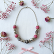 Rescued & Remade pink crackle necklace gift flat lay on white linen with pink dried flowers and ribbon
