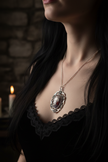 Gothic skull and rose cameo pendant necklace with ornate silver filigree worn around a neck, moody gothic lifestyle shot