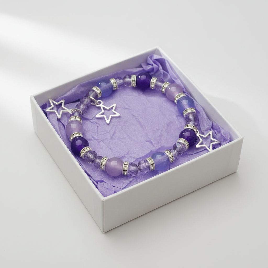 Purple and lilac star charm bracelet in a white gift box with purple tissue paper