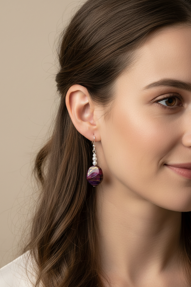 Rescued and remade plum drop earrings worn on a model
