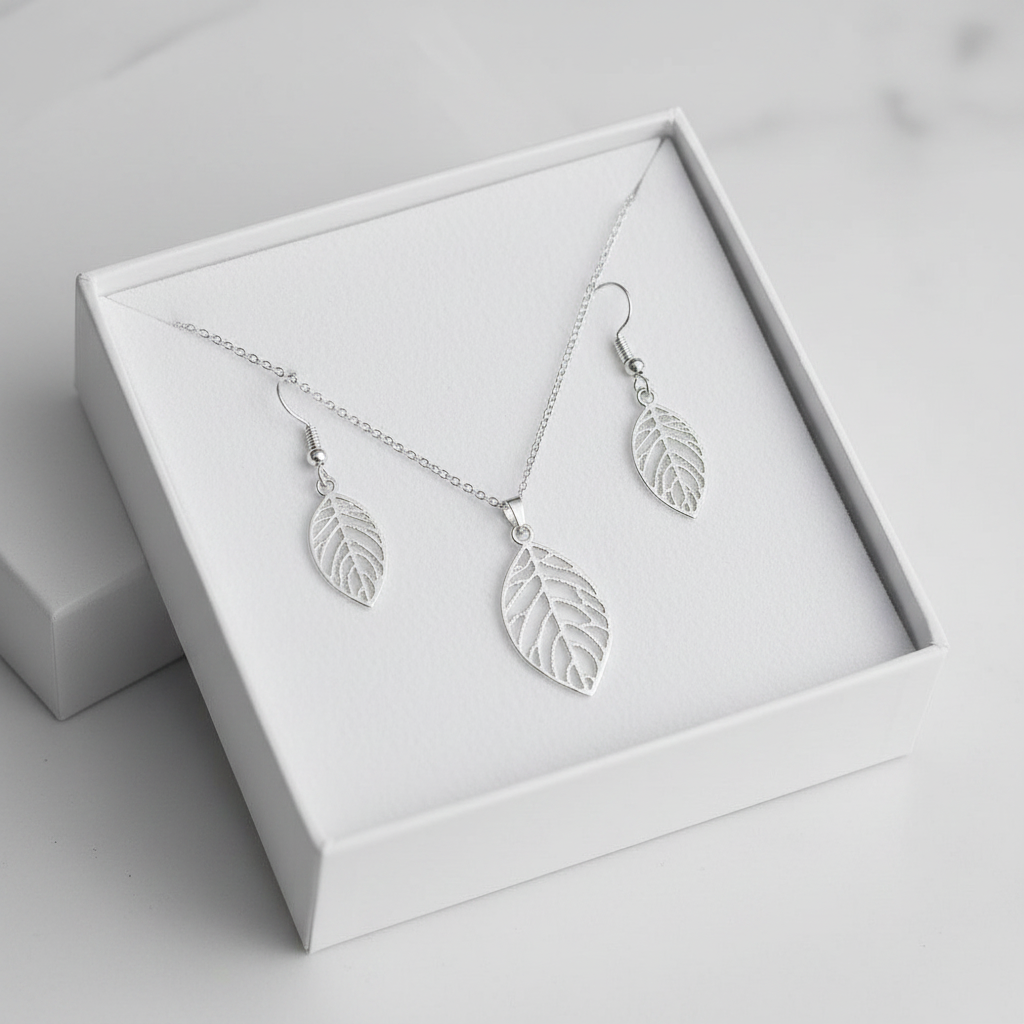 Silver filigree leaf necklace and earrings set in open white gift box