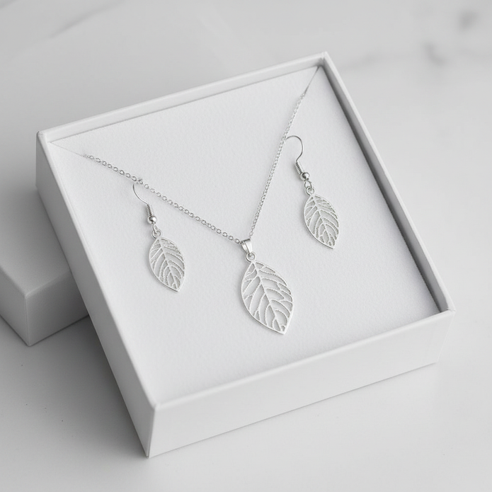 Silver filigree leaf necklace and earrings set in open white gift box