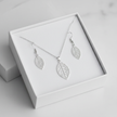 Silver filigree leaf necklace and earrings set in open white gift box