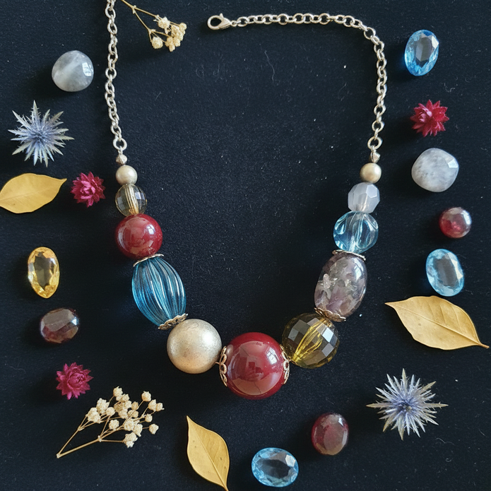 Rescued & Remade chunky mixed bead necklace flat lay on dark velvet with gemstones and botanicals
