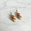 Copper pearl and gold textured bead drop earrings flat lay on white marble