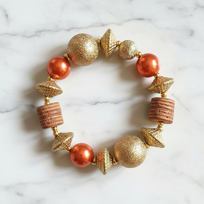 Copper pearl and gold mixed bead stretch bracelet flat lay on white marble
