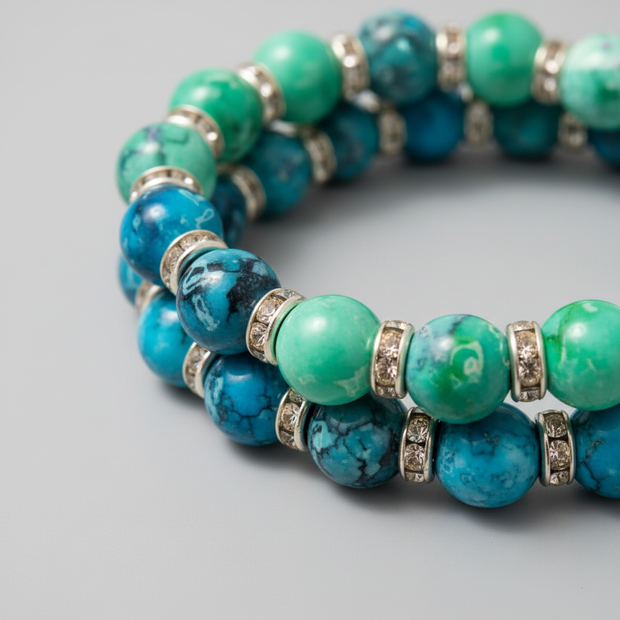 Close-up of two turquoise and green marbled beaded bracelets with diamante silver spacer rings