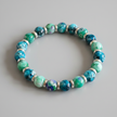 Close-up of turquoise and green marbled beaded bracelet with silver spacer rings