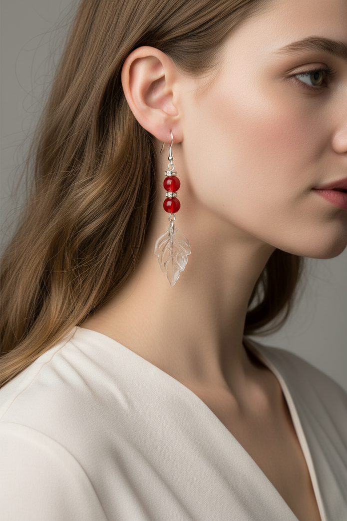 Model wearing red glass bead and crystal leaf drop earrings