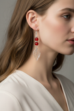 Model wearing red glass bead and crystal leaf drop earrings