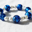 Close-up of cobalt blue foil glass and white pearl bracelet with silver rhinestone spacers