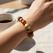 Woman wearing copper pearl and gold mixed bead stretch bracelet