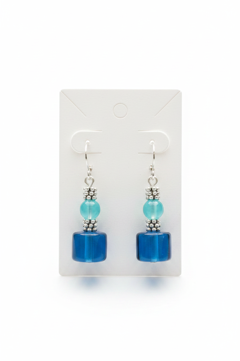 Blue glass cube and aqua bead drop earrings on a white display card