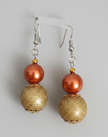 Copper pearl and gold textured bead drop earrings on dark background