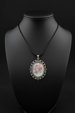 Sacred geometry mandala pendant necklace worn on neck form, dark background