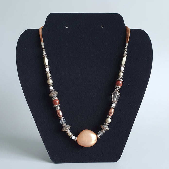 Necklace with beads on a black display stand