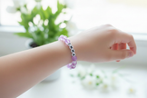 Purple EMMA bracelet on a girl's wrist