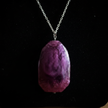 Close up detail of deep purple stone pendant on silver chain