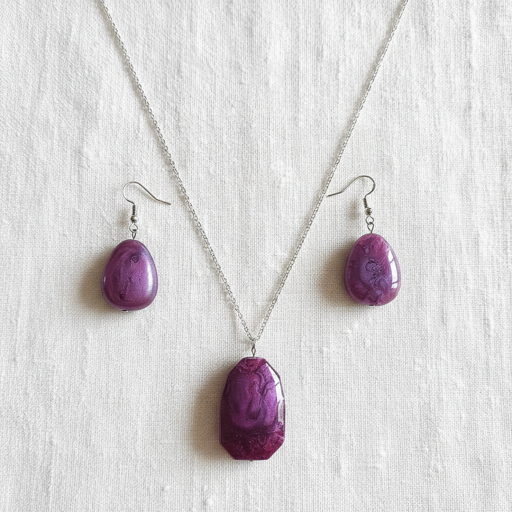 Flat lay of purple stone necklace and matching earrings on white linen