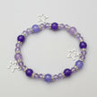 Purple beaded bracelet with star charms