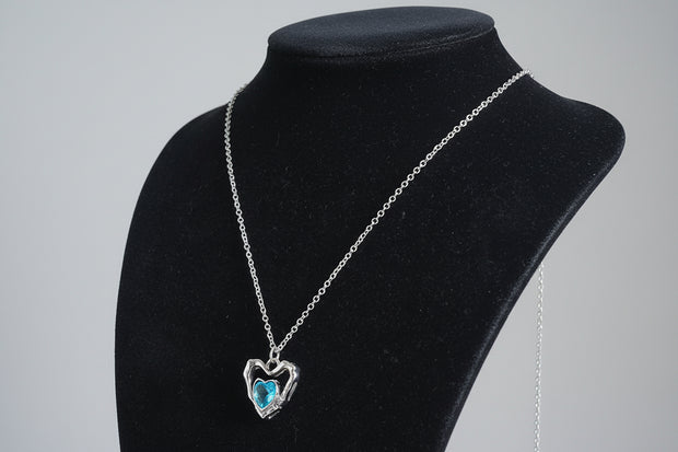 Necklace with a heart-shaped pendant featuring a blue gemstone